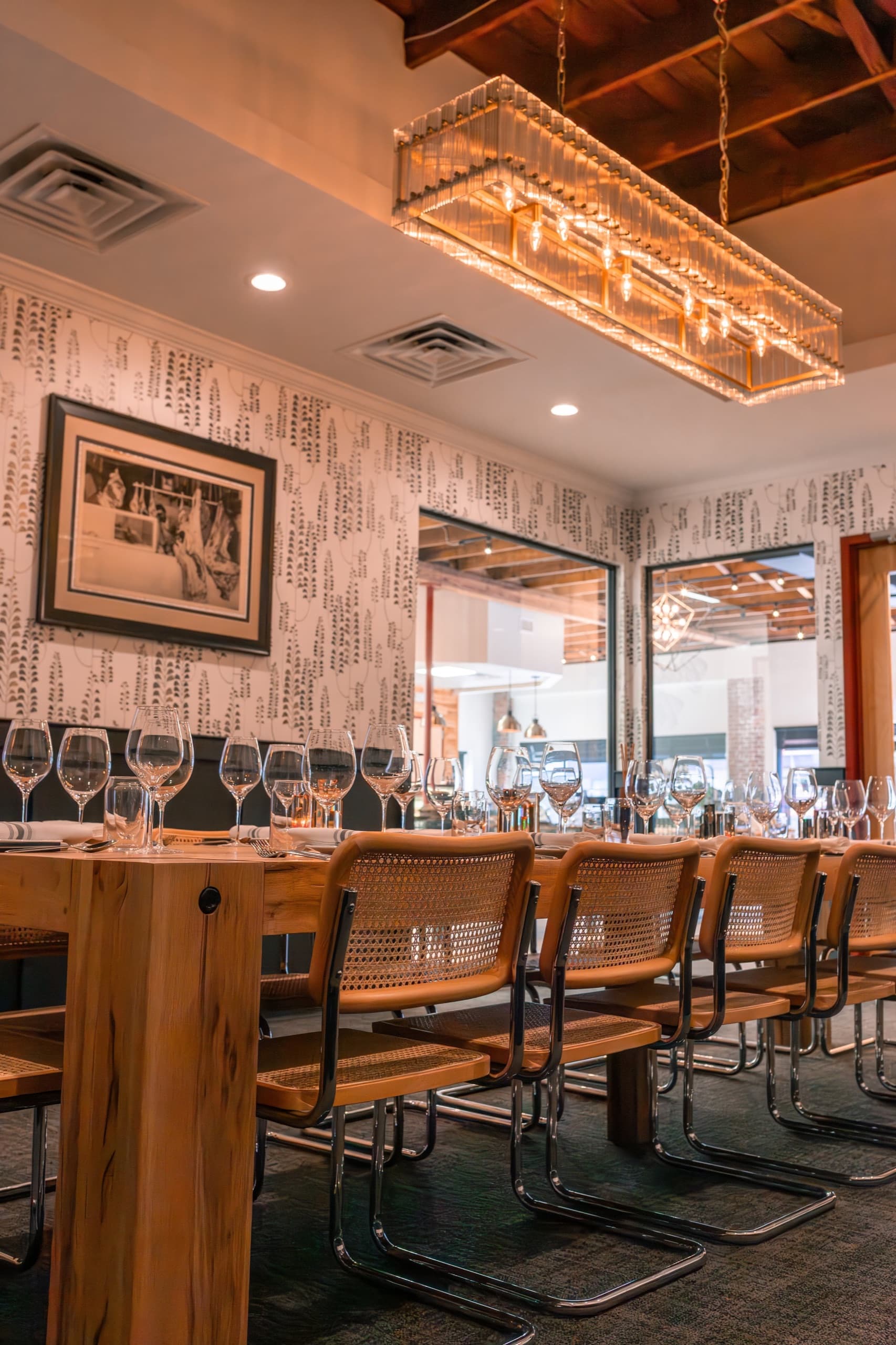 The Cline's Custom Meats dining room with a long wooden table set with wine glasses